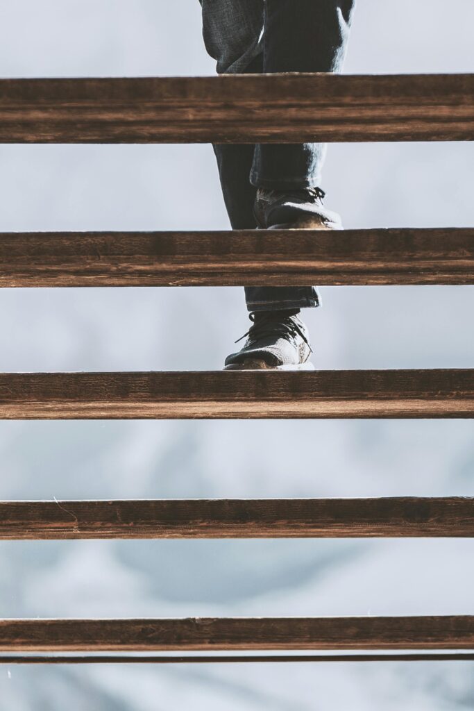 person climbing up a ladder