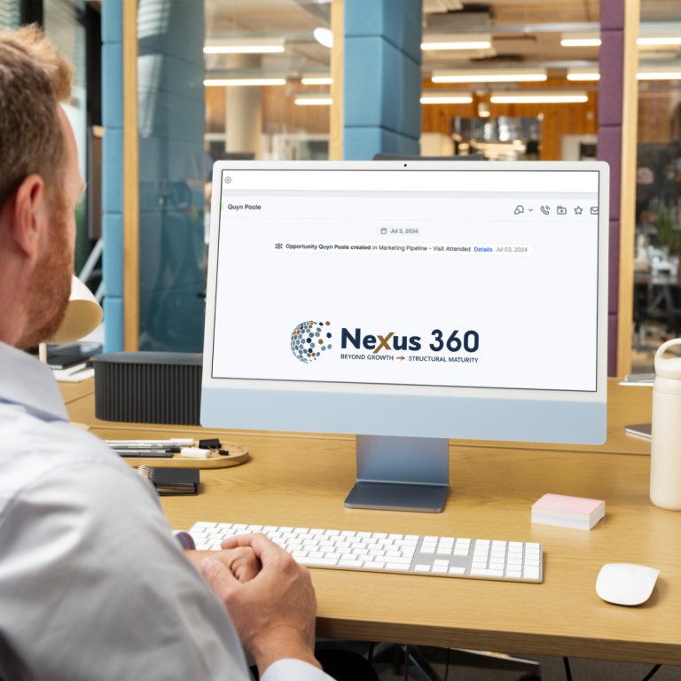 crm system not being used effectively in a growing business - a Man working at desk viewing Nexus 360 screen